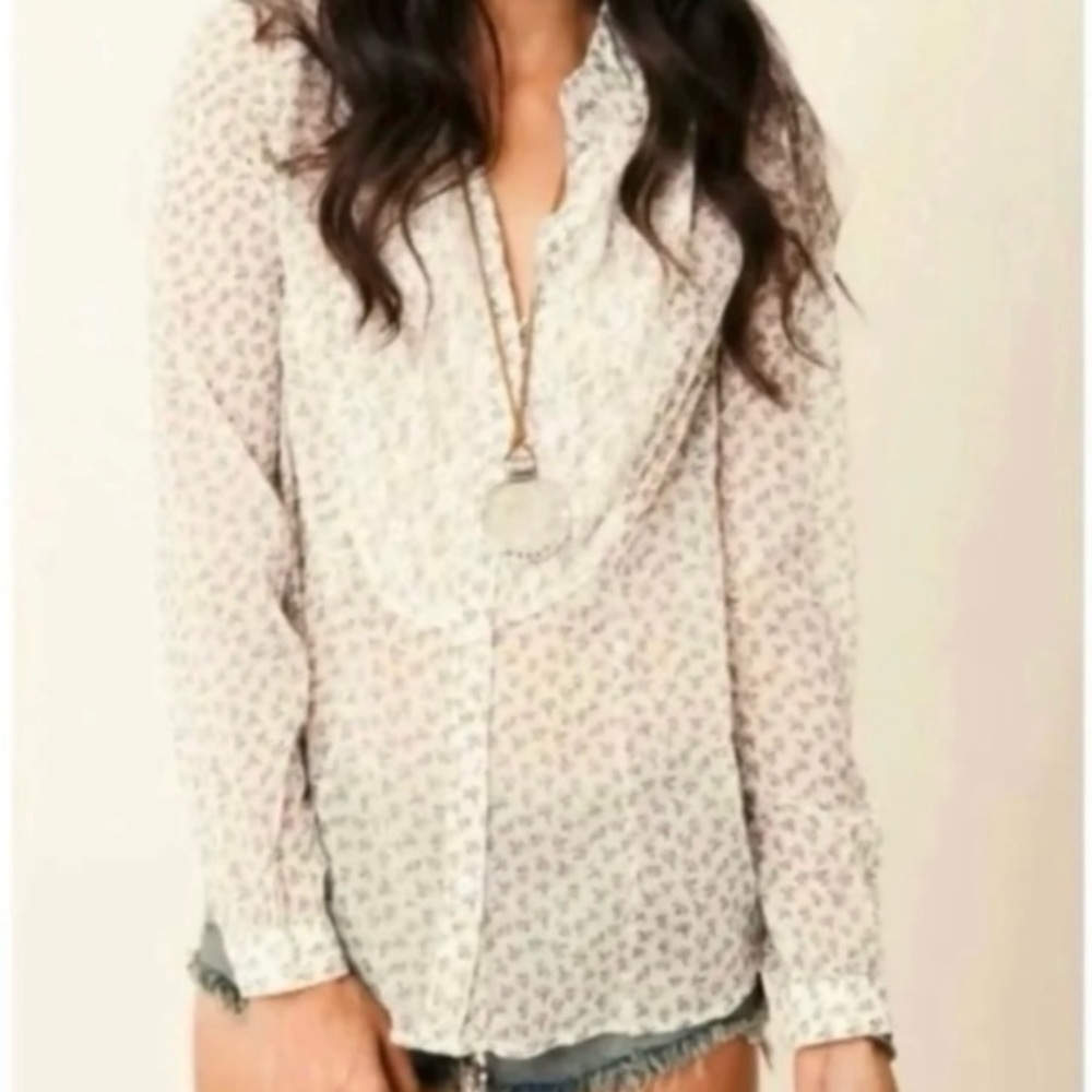 Free People front button blouse. Light cream with small black pattern.